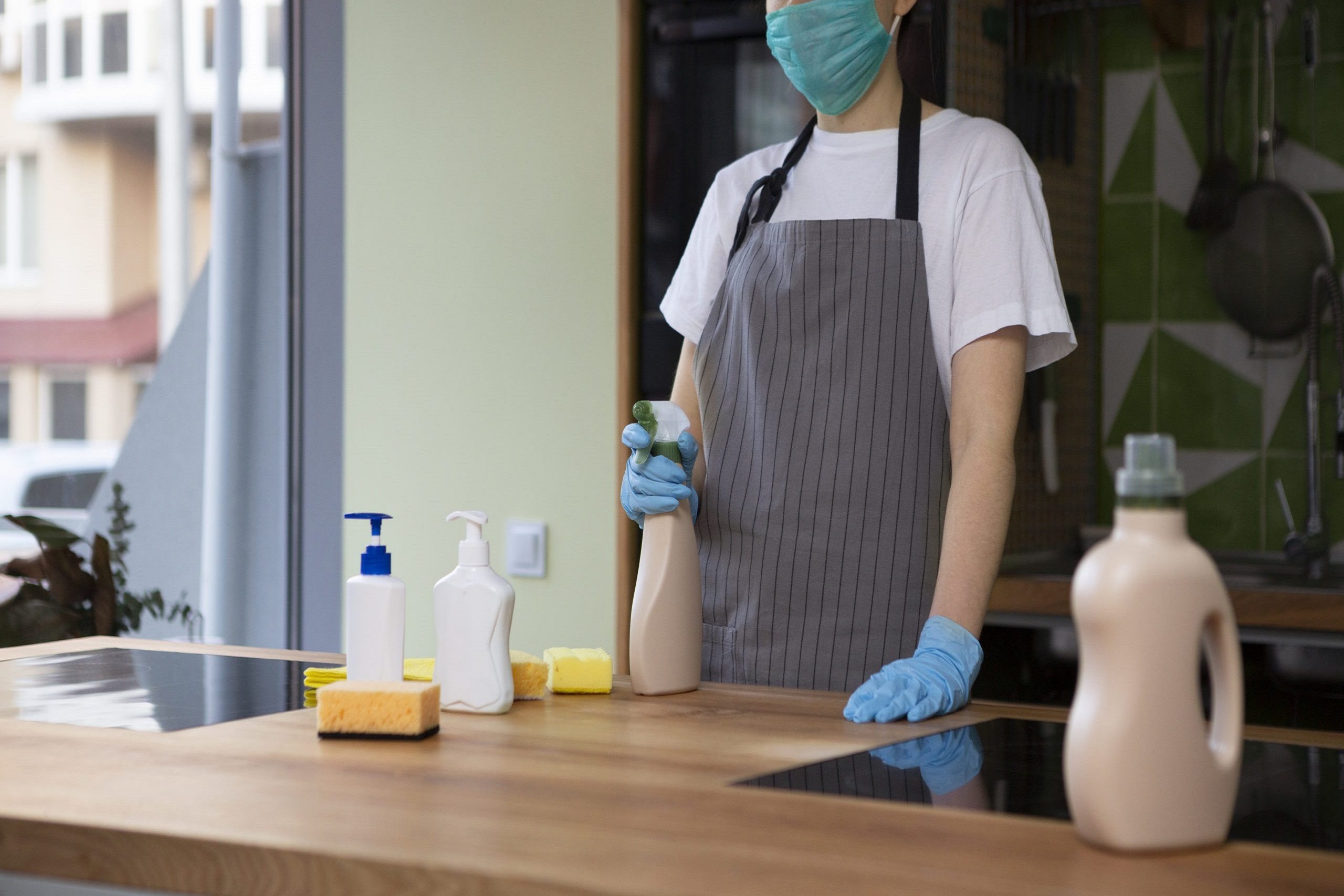Unrecognizable woman cleaning surfaces with different eco cleaning spray detergents, quarantine, panorama